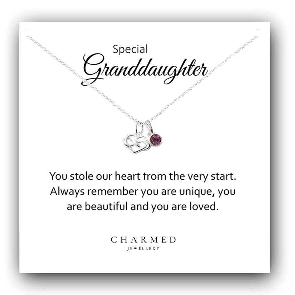 A sterling silver infinity heart necklace with a birthstone, presented on a card that reads 'Special Granddaughter' with a message. The necklace is shown with a chain and a heart-shaped pendant with a small gemstone.